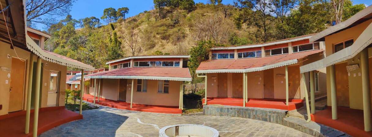 Large group in seated yoga class with props
